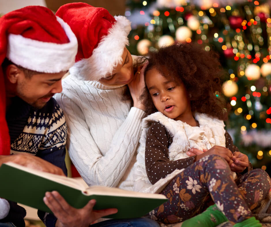 A family sits together, reading a book to their young daughter, creating a warm and engaging storytelling moment.