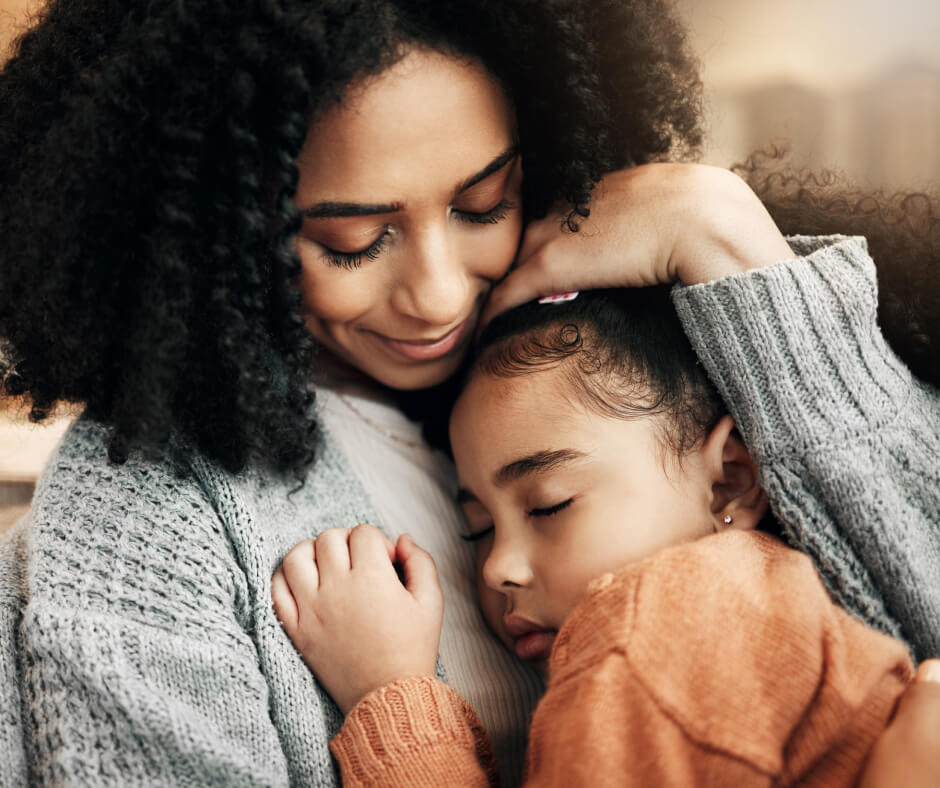 A mother and her daughter share a heartfelt hug, expressing their bond and affection for each other.