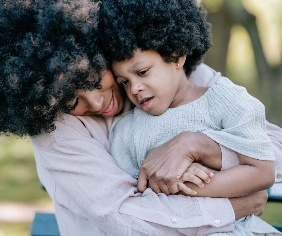 Mother comforting child with separation anxiety through loving embrace outdoors showing parental support and security